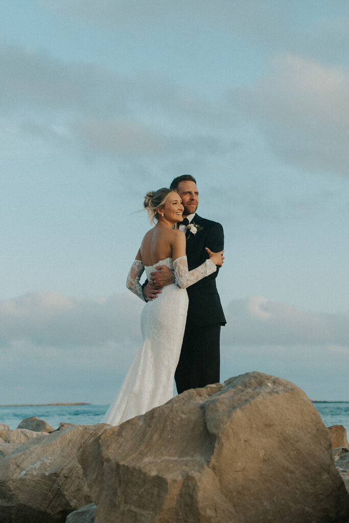 Bride and groom walking on the beach in Destin, Florida during golden hour – candid content creation by Sarah & Paul Creative